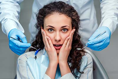The girl is afraid of the dentist. Close up view. young woman suffering from dental anxiety