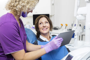 at a routine check up a woman talks to her dentist about dental checkups in gulfgate tx