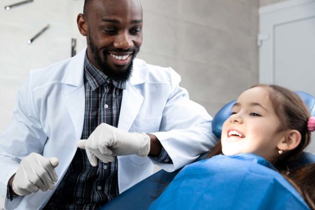 how-to-prevent-teeth-shifting (7) dentist helping child prevent teeth shifting