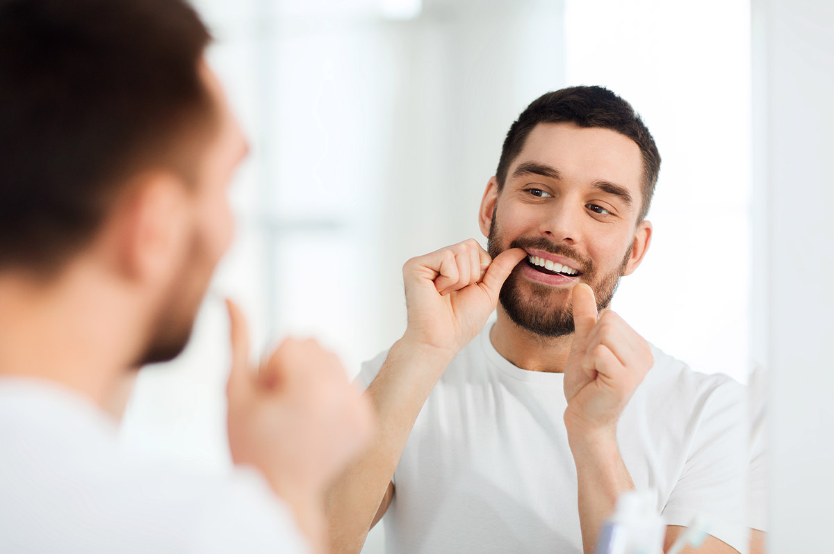 benefits of flossing daily man discovering the benefits of flossing daily