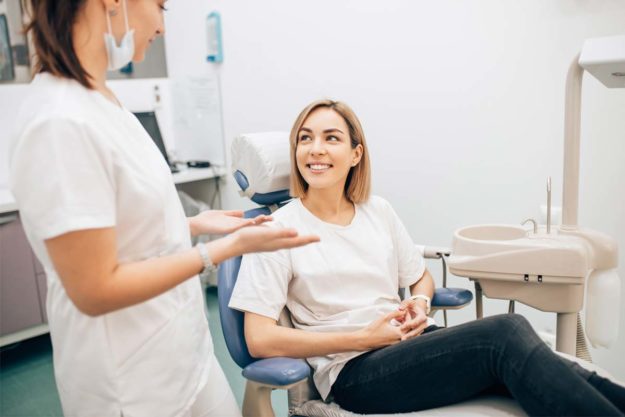 dental-exams dentist explaining dental exams to patient