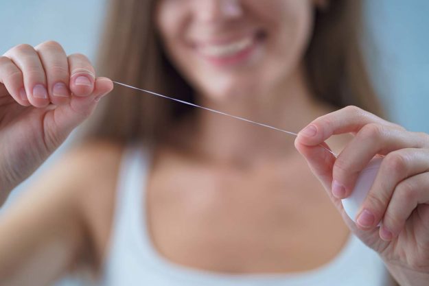 flossing (1) person showing what flossing looks like