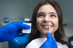 woman learning about dental crowns and dental bridges