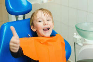 kid with thumbs up after dental bonding 