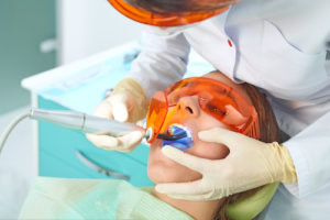 woman receiving dental fillings and sealants