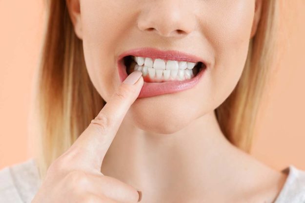 abscessed tooth woman dealing with an abscessed tooth
