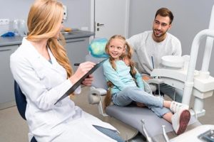 father and daughter learning about family dentistry 