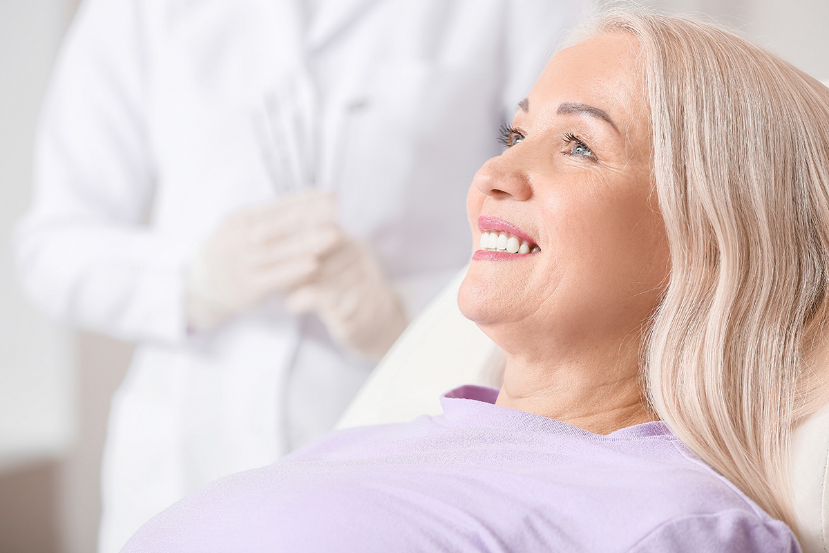 woman learning about her new dental implant